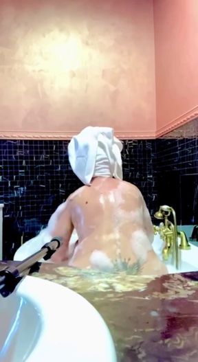 Stepmom Takes a Bath and Plays with Her Big Tits