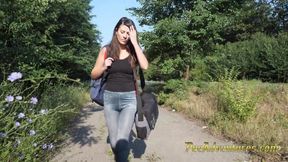 Skinny brunette hitchhiking  with her bladder full