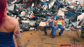 Red-haired milf seduces two guys into a threesome in the junkyard