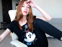 Sexy redhead camgirl exposes her slim body and tight peach