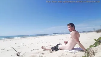 Twink strokes his cock on a sunny public beach