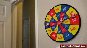 Two hot girls play a strip darts game with their male friend