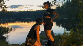 Strap-on blowjob by the beach