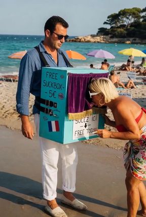 Man and Woman at Beach with Box