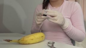 My Indian stepsister in white medical gloves sews a banana together with thread
