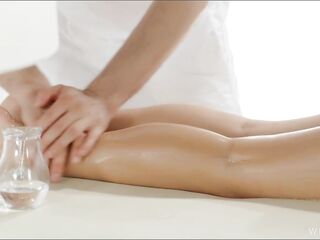 Warm Oil Leaks Down Her Curves as the Masseur Works Her Legs and Lower Back