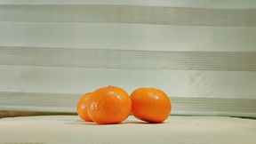 Food crushing barefoot orange fruit
