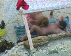 Amazing oral sex taped on the beach under the tent