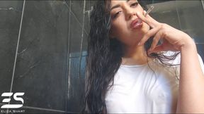 Smoking in a white wet shirt and wet hair