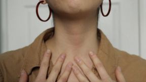 Aurora Touches Her Neck In Hoop Earrings