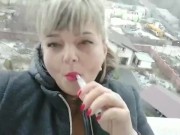 Hot pink lips smoking balcony