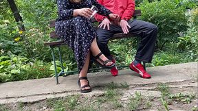 Hot MILF jerks off a big dick into a glass in the park on a bench