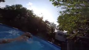 Cute twins wrestle naked in the pool