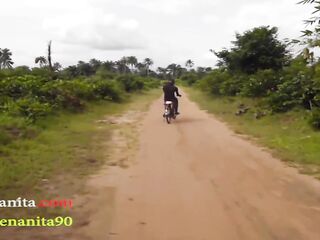 Afro woman with ebony, bushy hair is getting banged in the nature, during the day