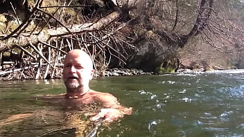 naked uncut bear chilling in the river