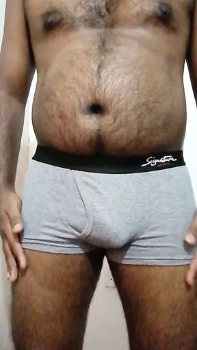 A horny Black Asian guy exercise with a stone to get a big dick