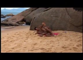 Anal doggy-style on the beach under the sun