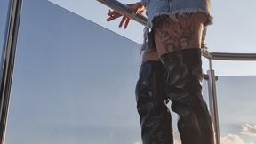 SEXY ON BALCONY SMOKER IN SKIRT DENIM & LEATHER BOOTS