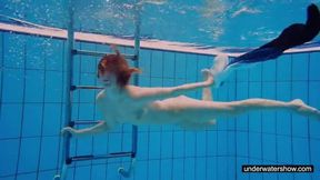 Teen girl Avenna is swimming in the pool