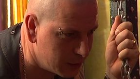 Tattooed Dom Fists Mature Blonde in Chains