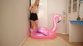 Cassie pop and deflate the inflatable pink flamingo