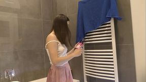 Sexy braless brunette in a pink mini skirt