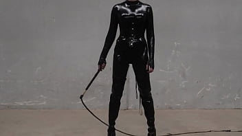 Transgender Mistress Obsidian Jones formidably wields her bullwhip whilst fully clad in black latex.