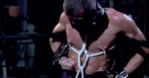 Chained male with stunning forms endures rough sexual punishments