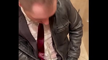 Office boss in Suit pissing on office boy in suit and leather