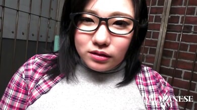 Voluptuous Japanese woman with huge tits explores pleasure in a brick-walled room