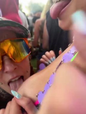 Curvy lesbian couple shares a kiss at public festival