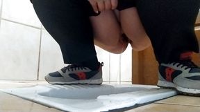 Curvy milf pissing in a dirty public toilet.