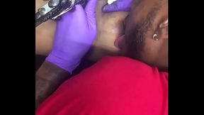 Horny tattoo artist multi-tasking sucking client'_s nipples