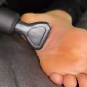 Ebony Girl Gives Her Feet a Massage with a Massage Gun