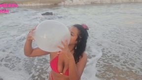Blowing condoms at the beach SFW
