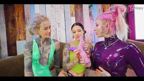 Two dominas gang up on Goth chick to fill her holes with toys and make her cum