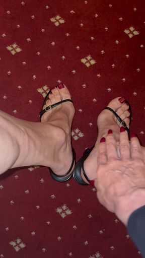 Stroking my feet while wearing black sandals