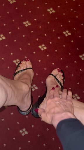 Stroking my feet while wearing black sandals