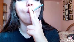 Big luscious lips with natural color lipgloss smoking cigarette