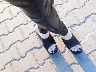 a walk in very high wedges and latex leggings