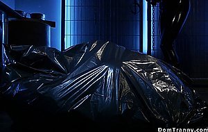 Shemale in latex gets blowjob from slave