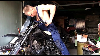 Muscular worker fucks motorcycle during repair