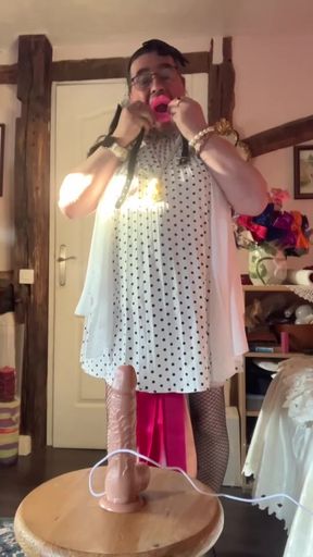In an outfit with a white pleated dress for an evening to suck a dildo with a mouth retractor