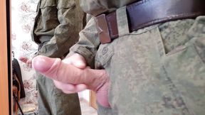 A Russian soldier in military uniform and dirty socks jerks off his dick