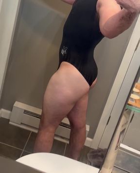 Adult swimsuit model in bathroom mirror