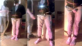 pee desperation: tied up by his flatmate, this guy tries to resist while his cock and balls are played with. he gets a boner and finally wets himself