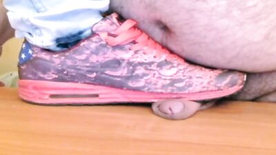 Kinky man in sneakers is trampling all over fat slave's cock and balls