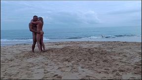 romantic dancing of a naked couple on a public beach