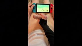 Femboy gets a hj from his mate while toying Nintendo Change