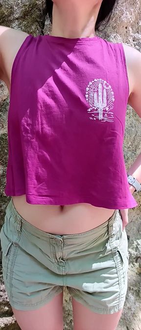 Playful Asian woman stretches her belly button